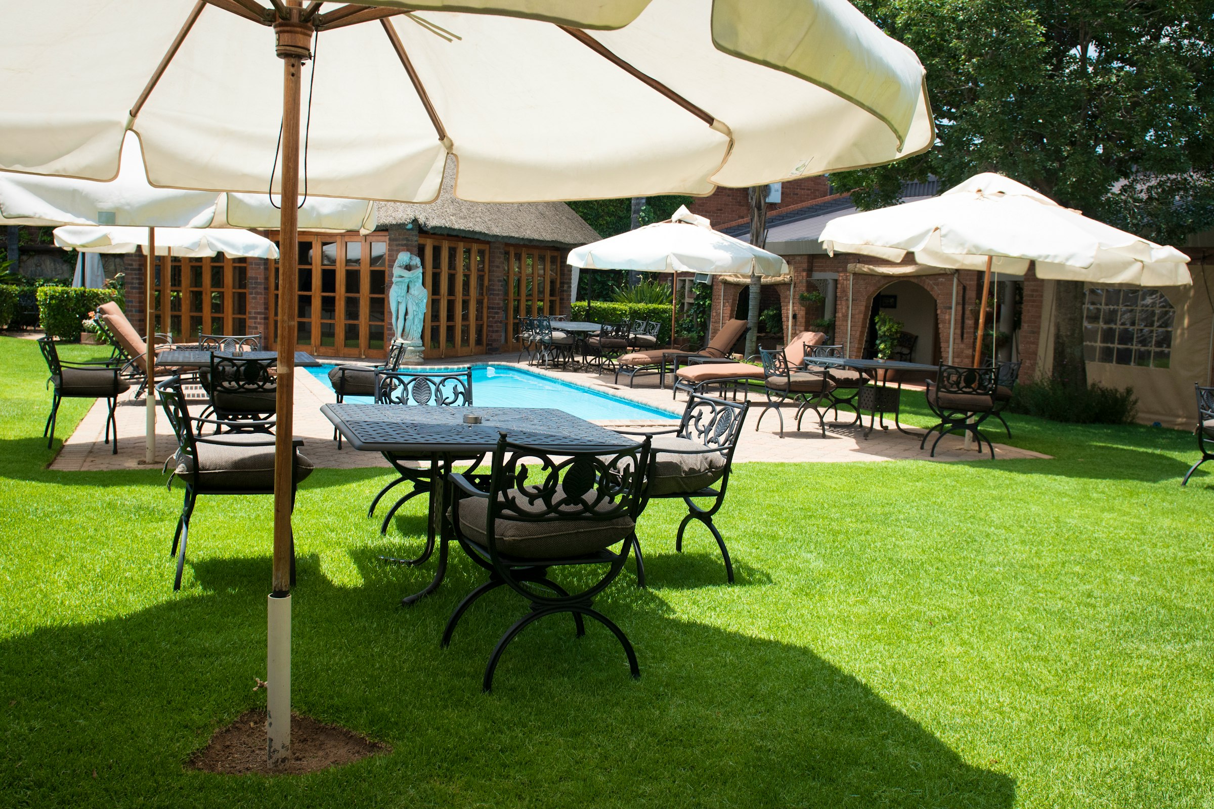 Au Jardin pool and lush garden surroundings