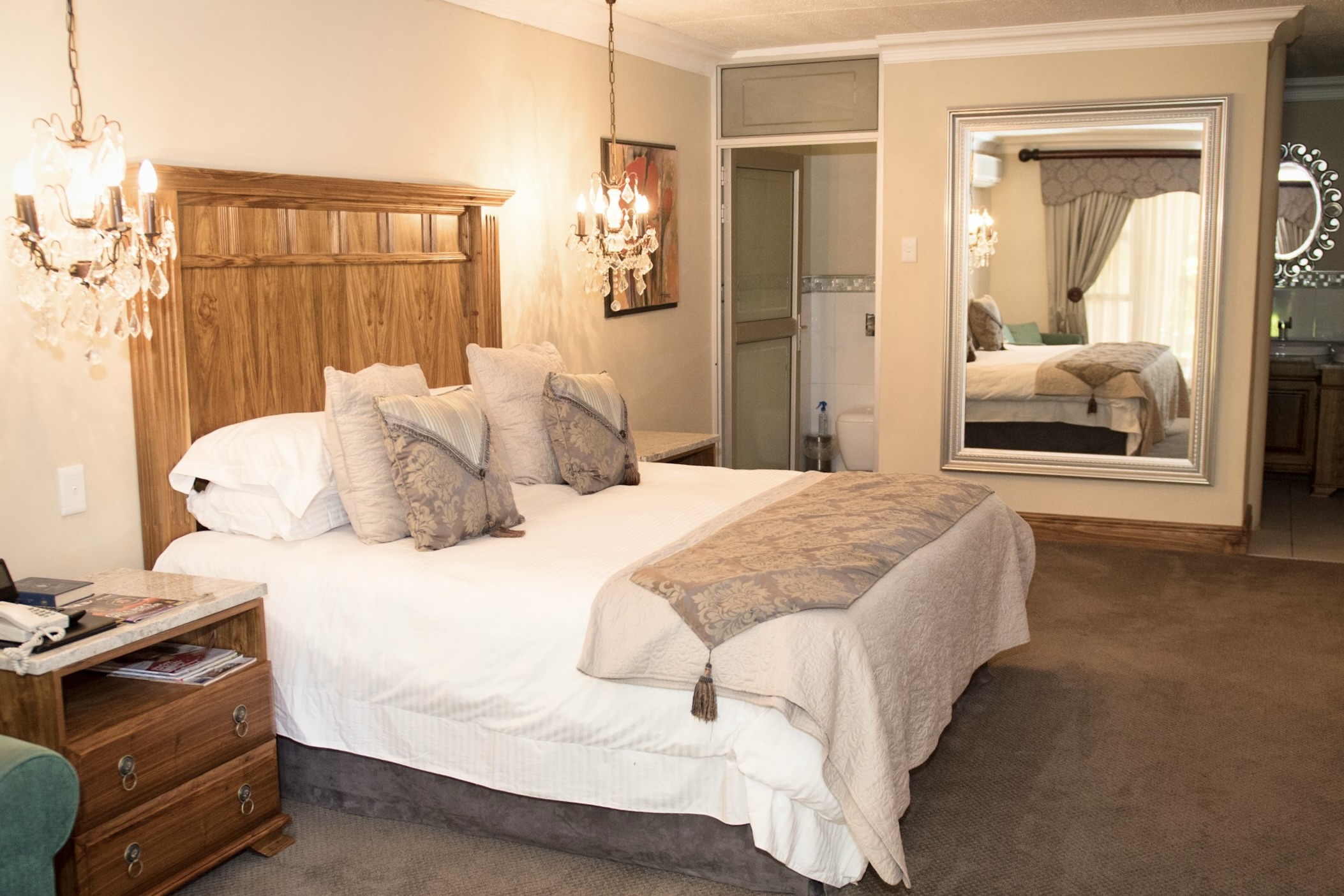 The elegant Cosmos bedroom suite with chandelier at Au Jardin Guesthouse